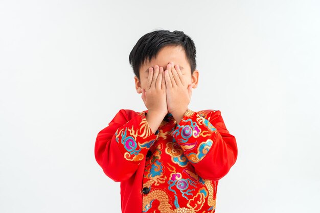 Copy space and Soft focus at little Asian boy covering his face with hands and playing hide and seek