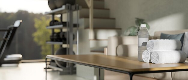 Copy space on wood coffee table over blurred home fitness room\
in background