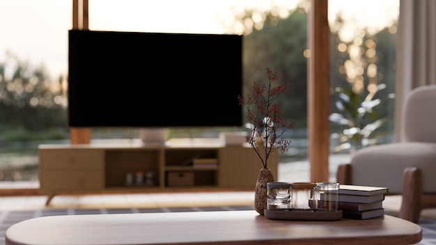 Copy space on wood coffee table over blurred living room with television in the background