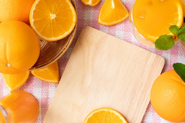 Copy space on wooden cutting board and orange frame.