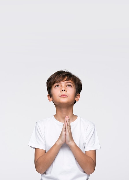 Copy-space young boy praying