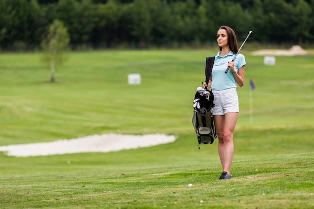 Photo copy space young golfer holding golf clubs