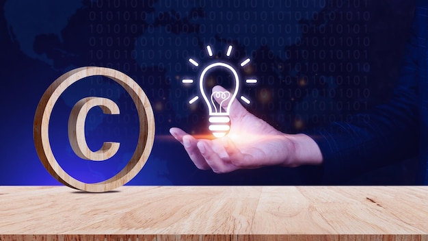 Photo copyright concept author rights and patented intellectual property copyright symbol protection sign on wooden table register trademark and logo