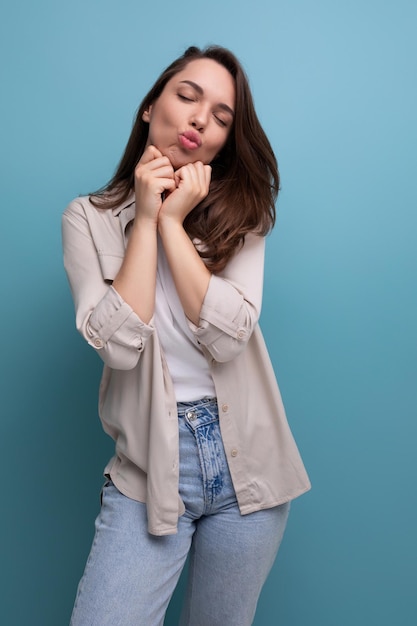 Coquette romantic young brunette woman in shirt and jeans