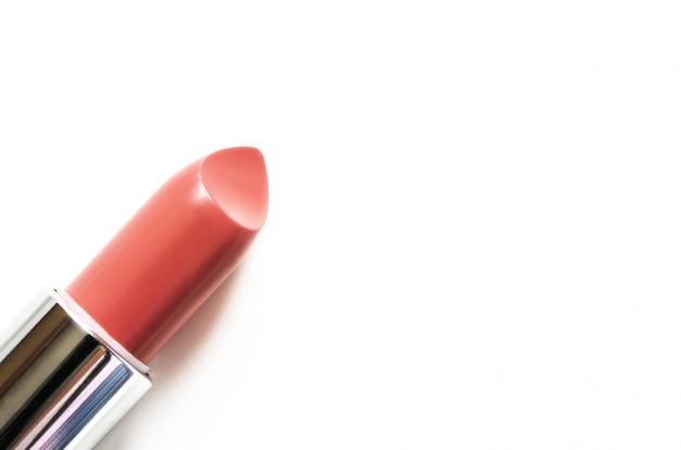 Coral lipstick isolated on white. 