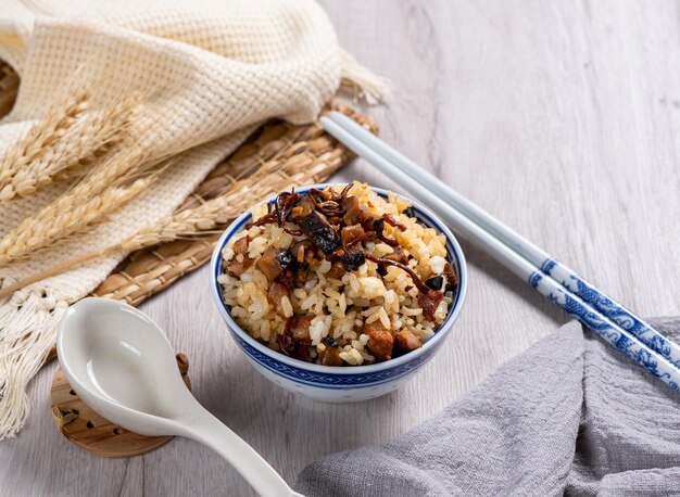 Cordeceps flower rice in a bowl with spoon and chopstick top view on table