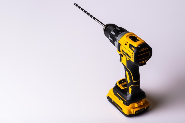 Cordless drill and a drill on a white background