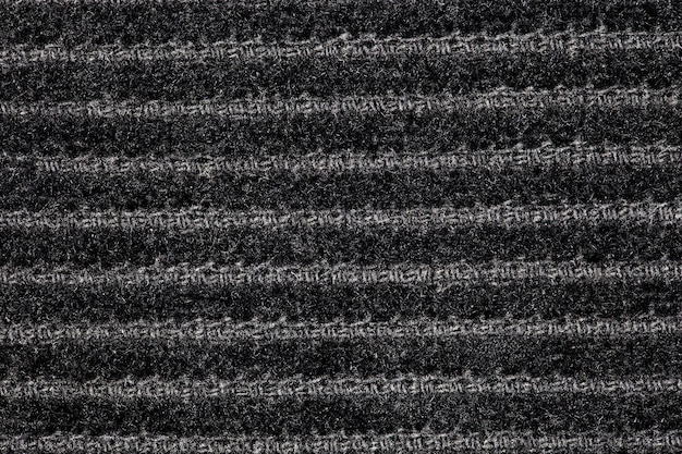 Corduroy black fabric with furrows horizontally background wallpaper uniform texture pattern