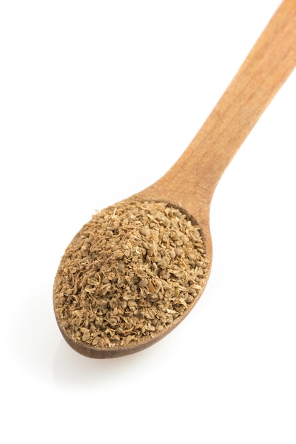 Coriander powder and spoon isolated on white