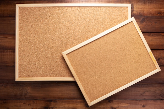 Cork board on wooden background texture