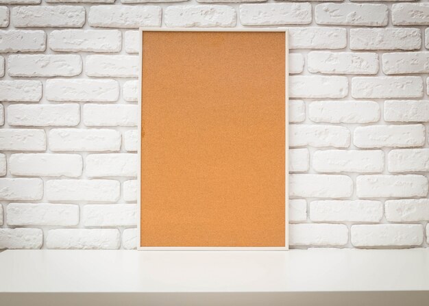 Cork bulletin board on white brick wall