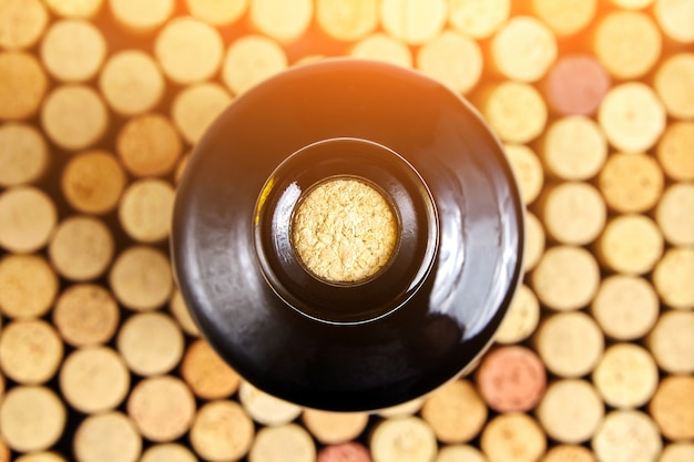 Corked glass bottle of red wine, top view.