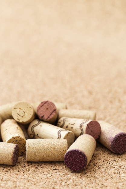 Corks from wine bottles on wooden background. 