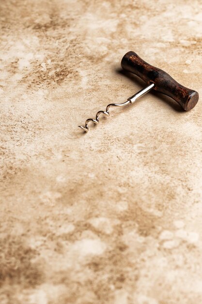 Corkscrew on brown textured background with copy space Rustic style