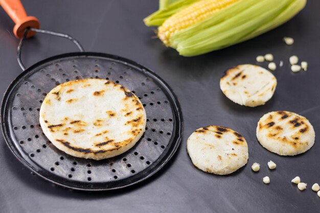 Corn arepa traditional Colombian food on a grill