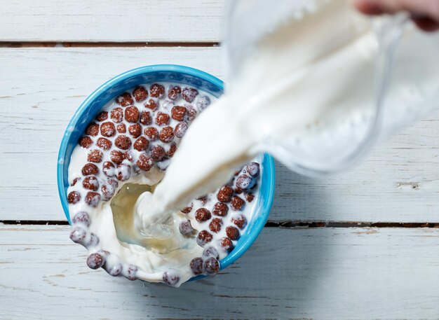 Corn balls breakfast with milk being poured over it