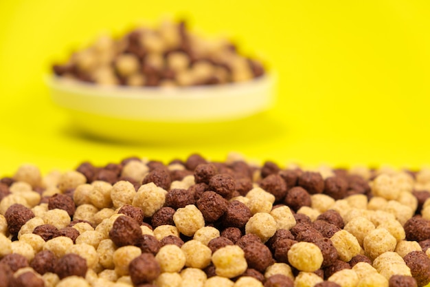 Corn balls with cocoa on a yellow background Quick cereal healthy breakfasts for children and adults