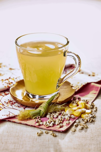 Corn and barley drink served in a cup isolated on napkin side view of hong kong food