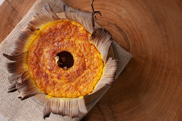 Corn cake in the straw. home made cake. typical of brazil and south america. top view. space for text