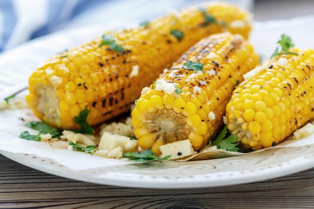 Corn on the cob grilled with soft cheese and cilantro