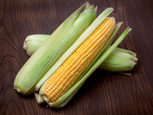 Corn on cobs on rustic table