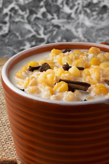 Corn cooked with milk and cinnamon sticks known as canjica