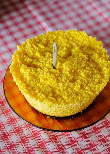 Corn couscous on table with red and white tablecloth Popular dish Brazil consumed for breakfast