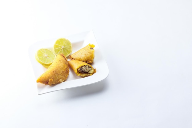 Corn empanada typical Colombian food with lemon and copy space