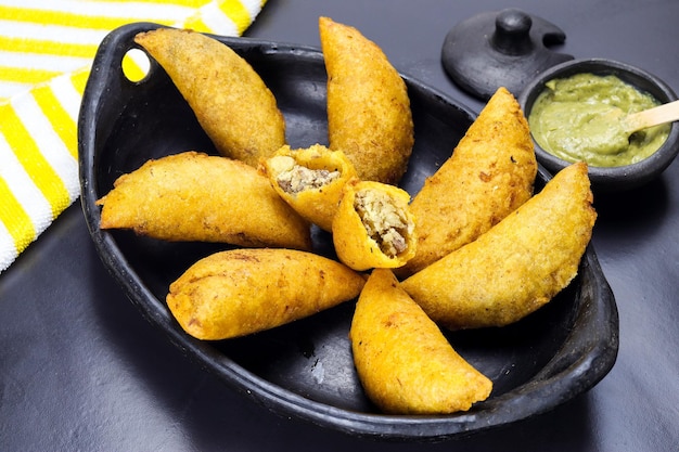 Photo corn empanada typical colombian food with spicy sauce