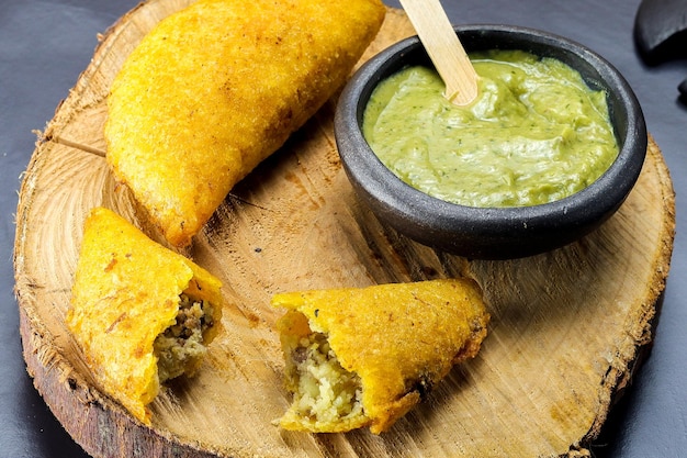 Corn empanada typical colombian food with spicy sauce