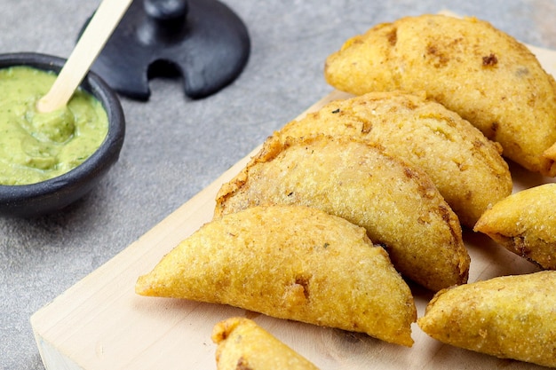 Corn empanada typical Colombian food with spicy sauce