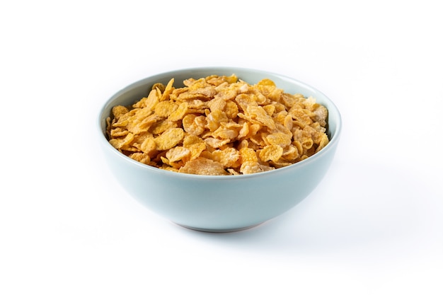 Corn flakes in a blue bowl isolated on white
