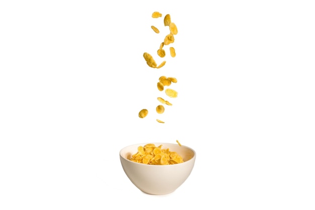 Photo corn flakes falling to the white bowl motion