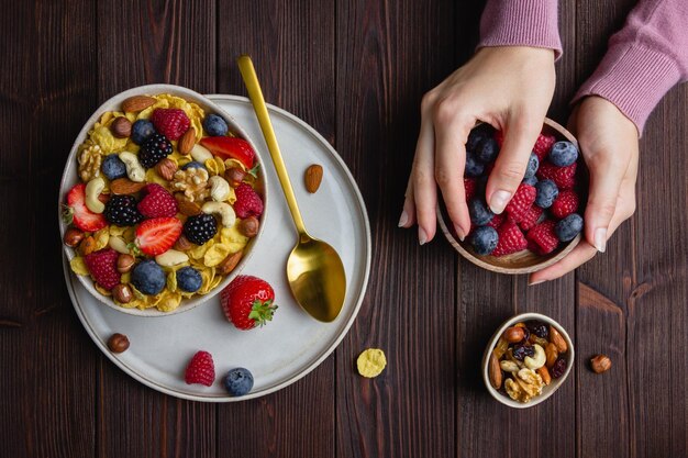 Corn flakes with berries and nuts in bowl