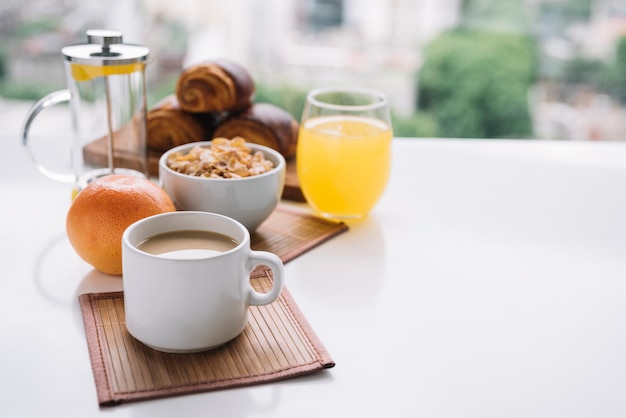 Corn flakes with coffee cup on table