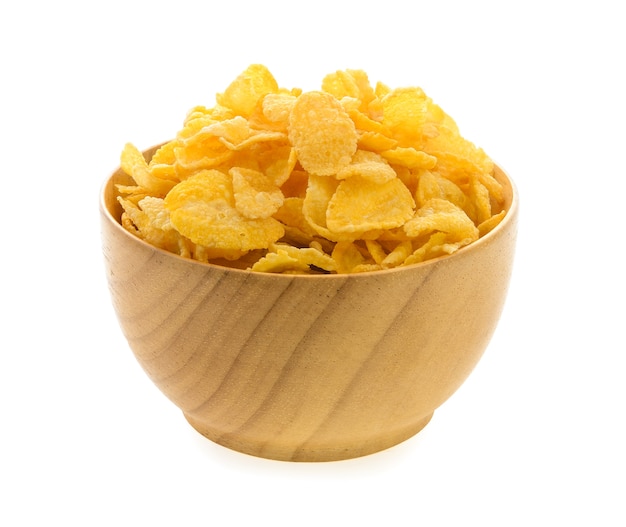 corn flakes in wood bowl isolated on white background