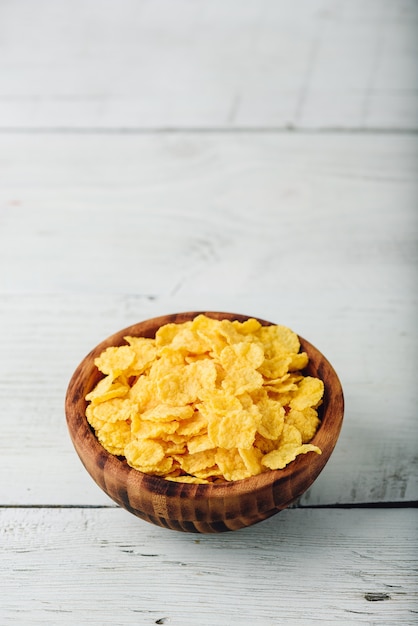 Corn flakes in a wooden rustic bowl