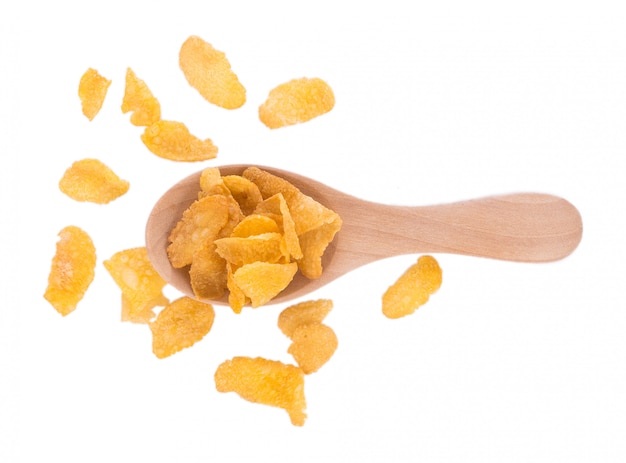 Corn flakes in wooden spoon isolated