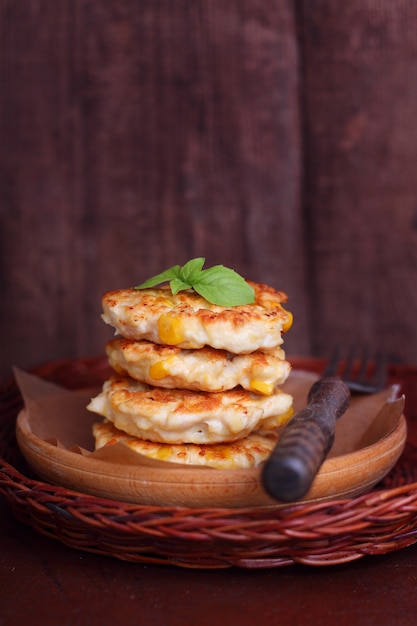 Corn fritters on a dark wooden background