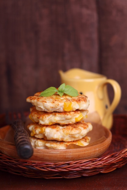 Corn fritters on a dark wooden background