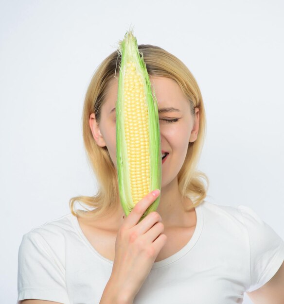 Corn harvest Girl hold ripe corn Food vegetarian and healthy natural organic products Vegetarian menu Eat corn benefits Healthy food concept Woman hold yellow corn cob white background