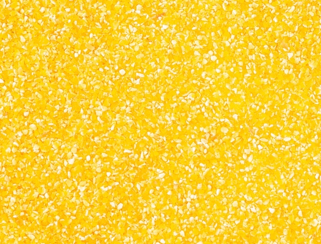 Photo corn or maize grits texture. raw italian polenta background