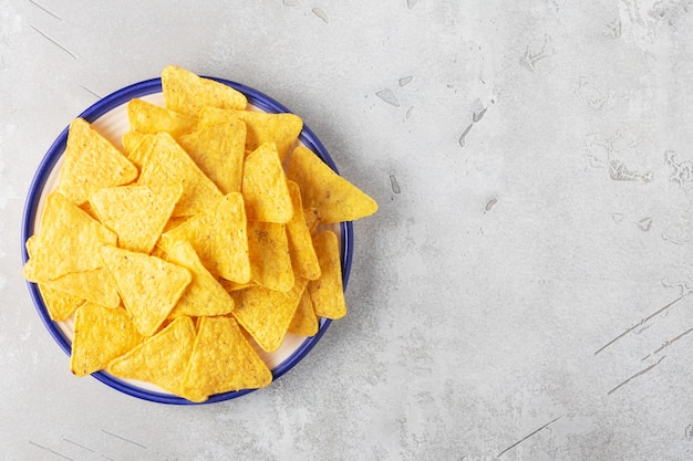 corn nachos in a plate on a gray background horizontally