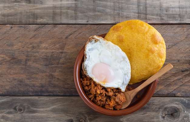 Corn pancakes with minced meat and fried egg. Typical Spanish cuisine. Copy space.