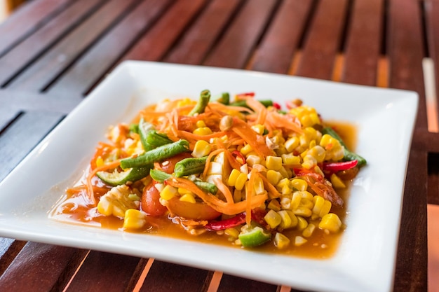 Corn seeds with fruits and vegetables sour spicy in plate