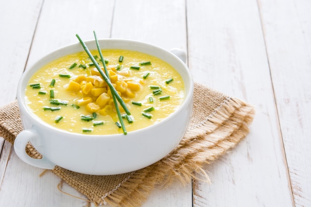 Corn soup in white bowl on wooden  