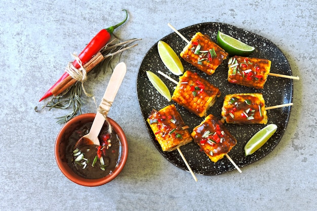 Corn on sticks with chili lime sauce.