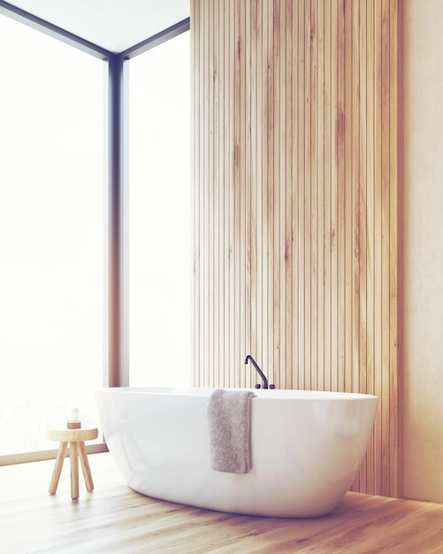 Corner of a bathroom with bathtub and a small wooden chair toned