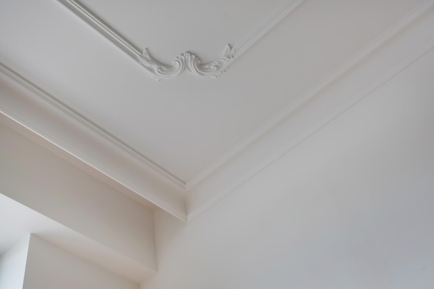 Corner of ceiling and walls with intricate crown moulding Interior construction and renovation concept
