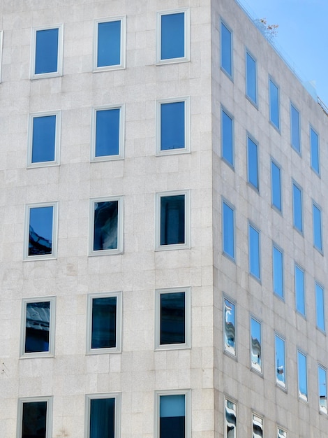 Corner of minimal building facade with simple glass windows Vertical photo